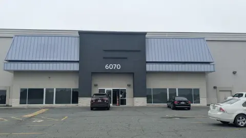 The original commercial building at 6070 East Independence Blvd in Charlotte, NC, before Ossa Studio converted it into Vizion Church.